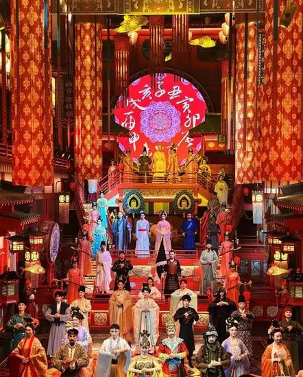 Performers in Tang dynasty costume on a lantern-lit palace stage